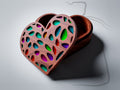 JB5 heart jewelry box CNC files, wood finish render, open view with lid leaning against base showing perforated cutout pattern and smooth interior cavity