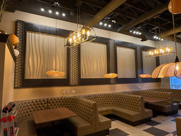 BFW wave panels displayed as multiple framed artworks on dark walls in a restaurant lounge, white panels with dark frame finish, modified BFW WP11 design