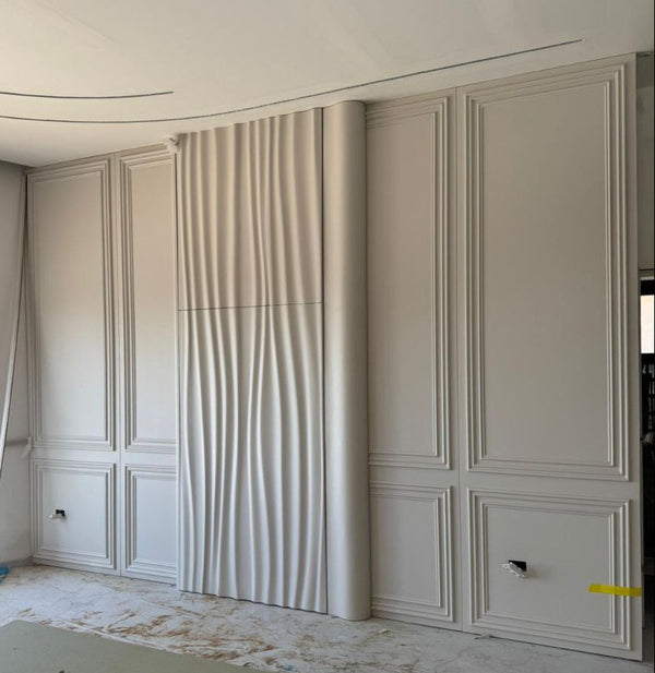 Concealed door with CNC wave relief panel integrated into a full-height wall unit with classical panel molding, white painted finish, WP11 modification designed by BFW and fabricated by client