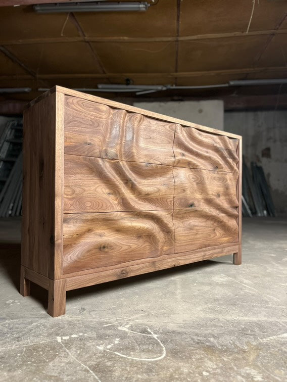 Solid wood chest of drawers with CNC wave relief carving across front panels, warm wood finish, modified BFW WP8 design